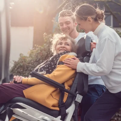 Para transit senior woman wheelchair smiling adults pushing a woman in a wheelchair