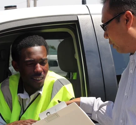 SCR_driver_02-16-22b-crop-no-t-591w-544h a man talking to another man in a car